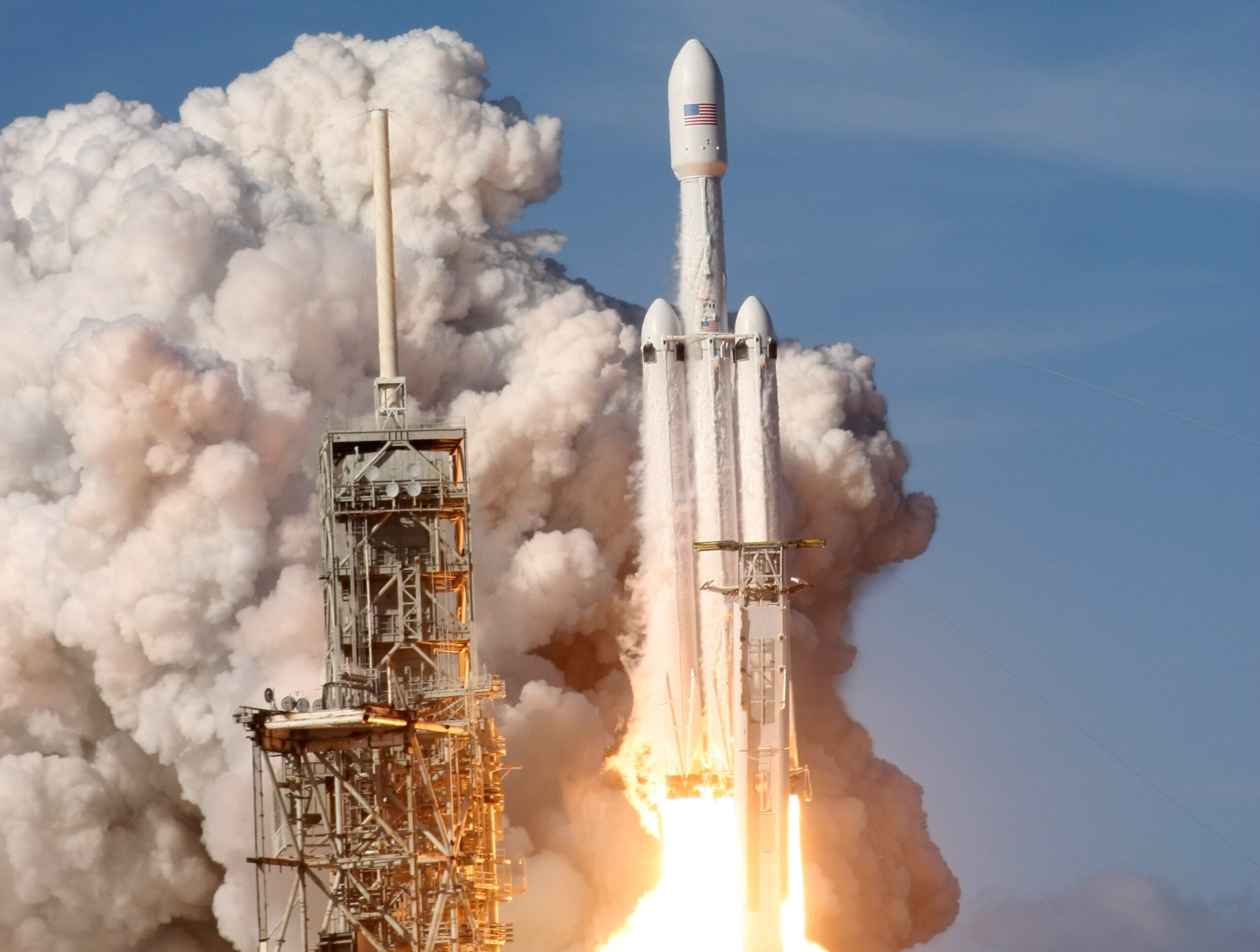 A SpaceX Starship rocket launching towards Mars in a starry sky, symbolizing space exploration and technology.