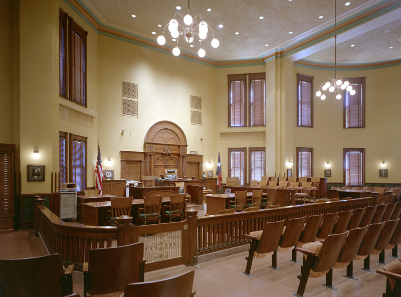 A Texas federal courtroom scene depicting a judge and defendant involved in a cryptocurrency case.