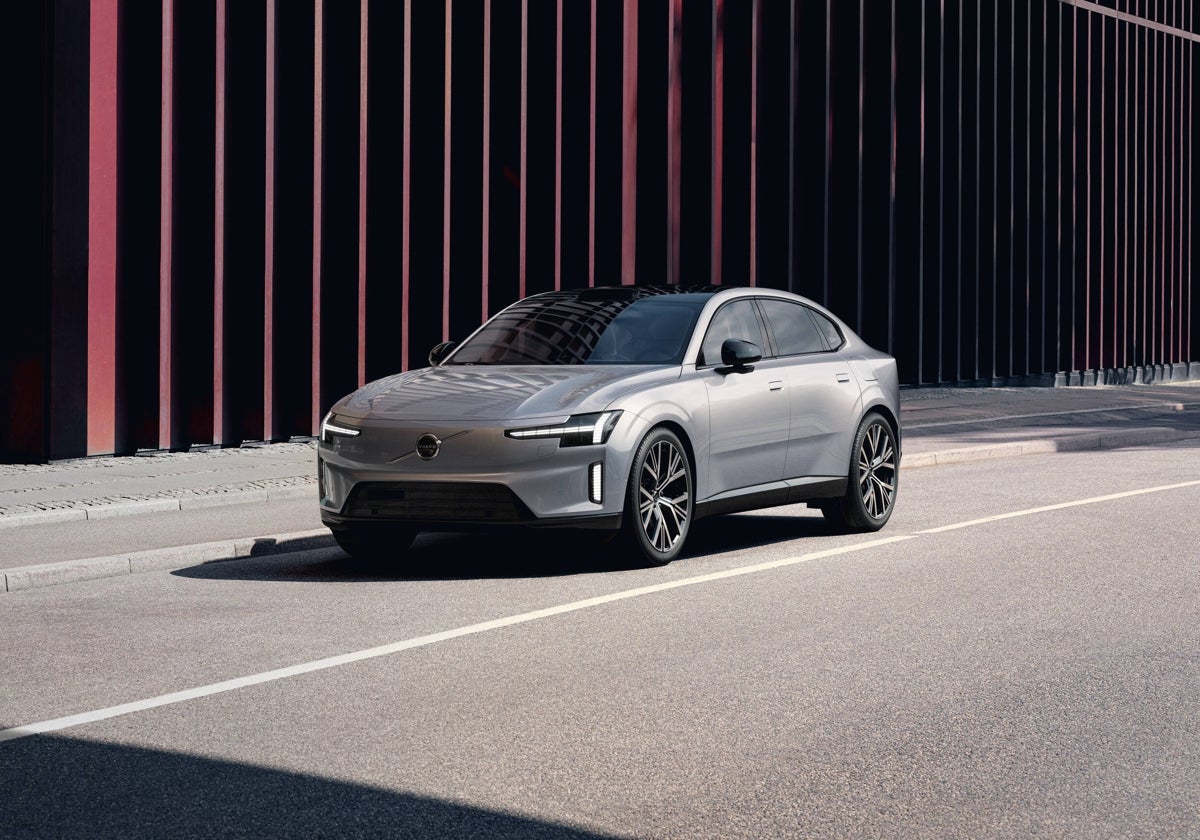 Futuristic Volvo ES90 car with NVIDIA technology in a high-tech urban setting, illuminated by neon lights and displaying a minimalist design.