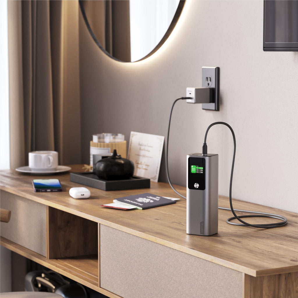 Ark Pro power bank with USB-C cable and digital display in a modern tech setting.