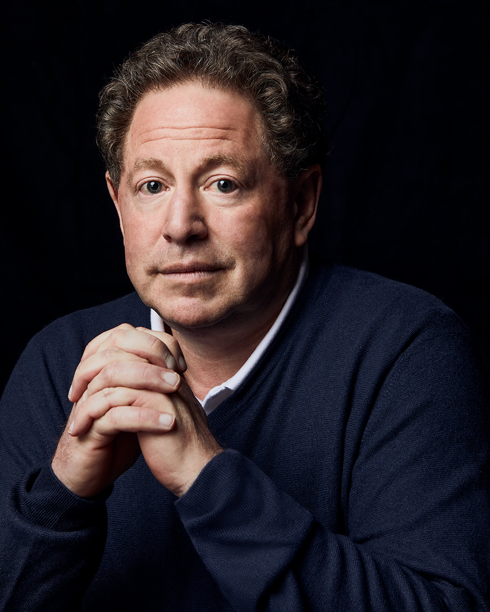 A modern artistic representation of Bobby Kotick, the controversial CEO of Activision Blizzard, surrounded by gaming elements and vibrant colors.