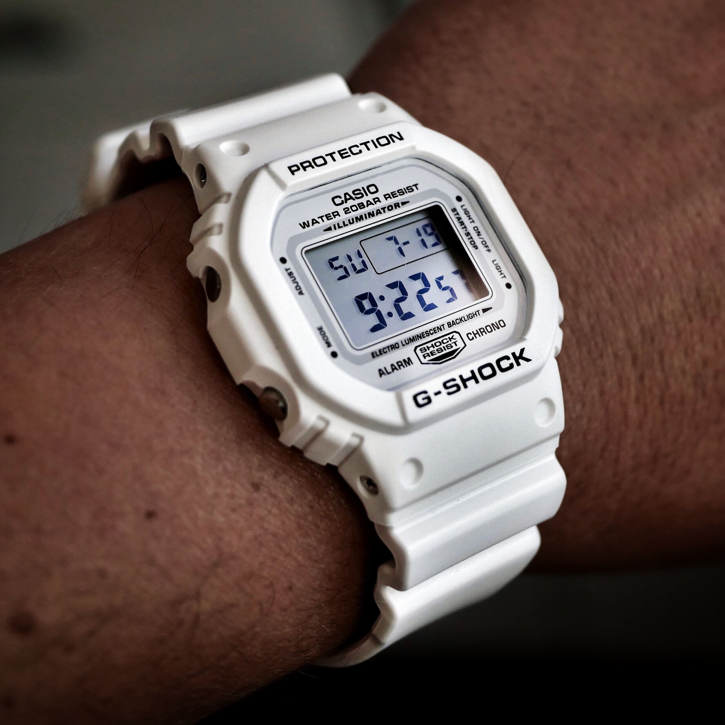 A flat lay of the Casio G-Shock DWE-5600UD-1 watch with Undefeated branding, styled with urban accessories.