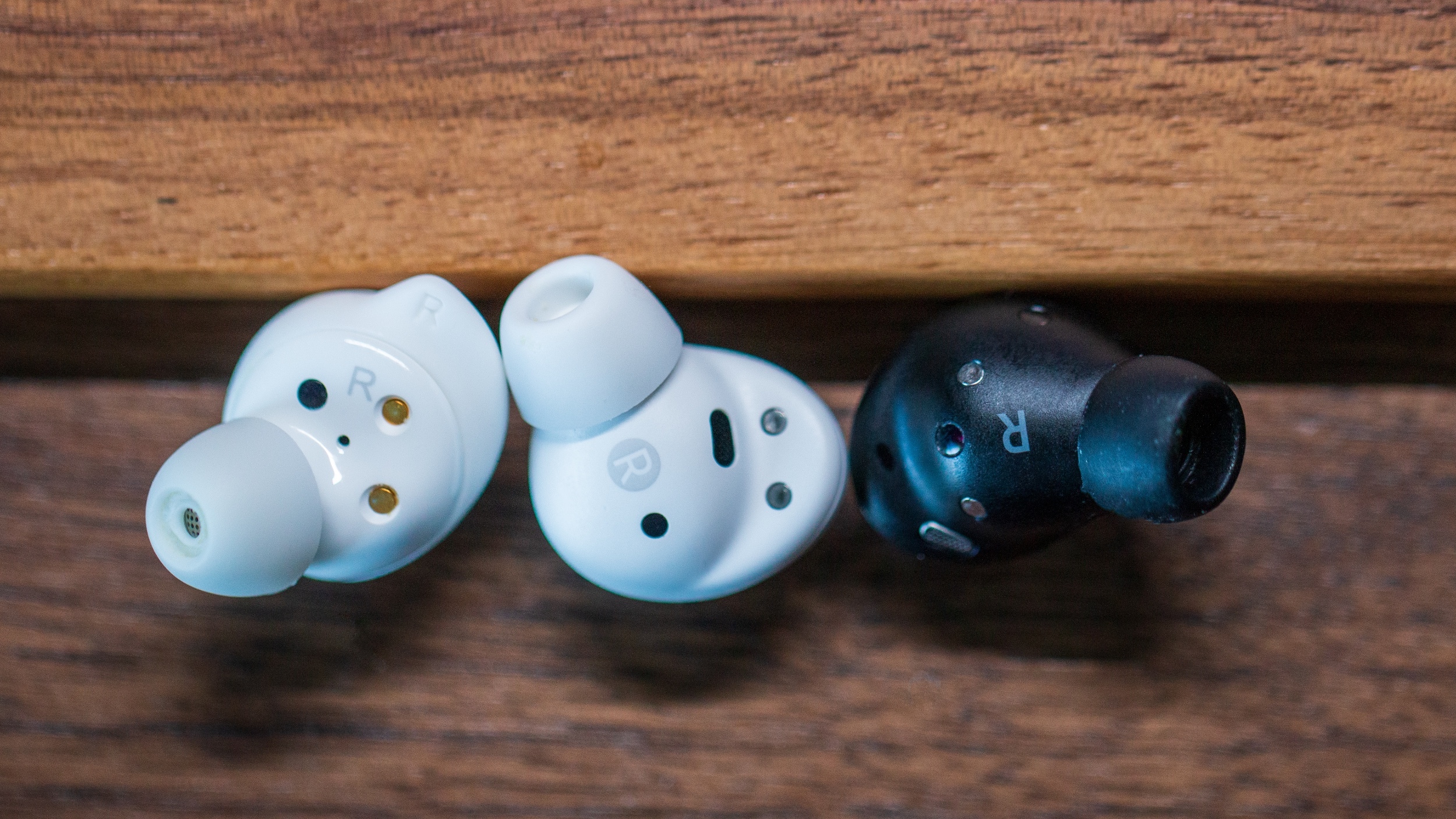 A modern, sleek image of Galaxy Buds FE 2 wireless earbuds in a dynamic, technology-inspired setting.