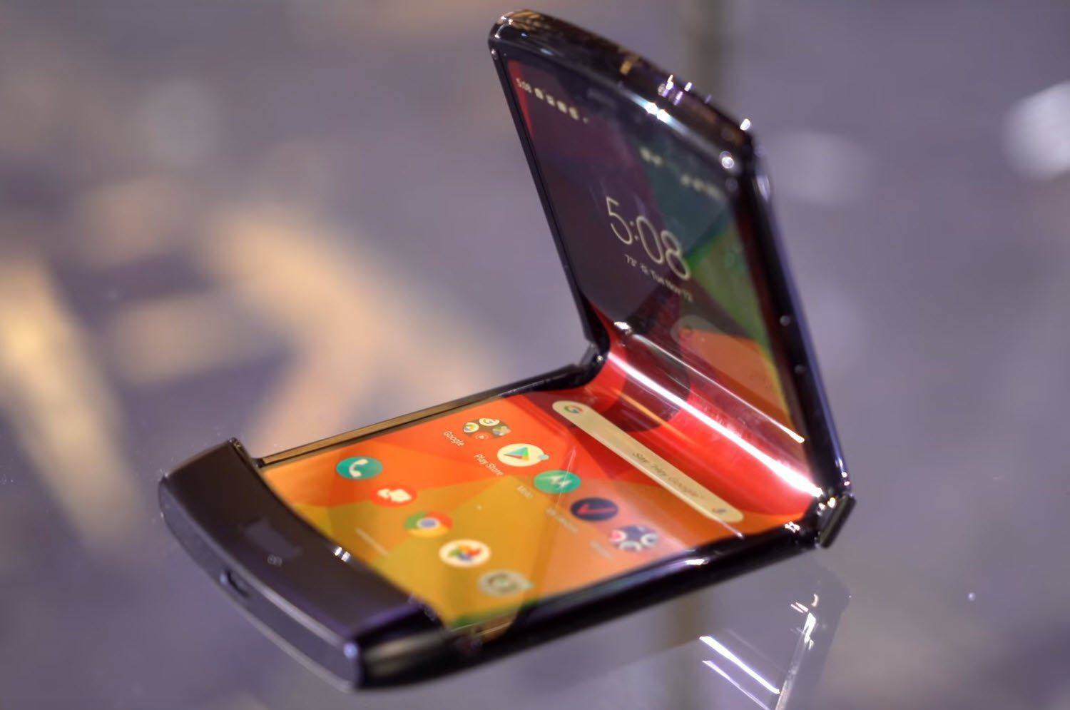 A stylish and modern representation of a foldable Motorola smartphone, highlighting its innovative design in a sleek environment.