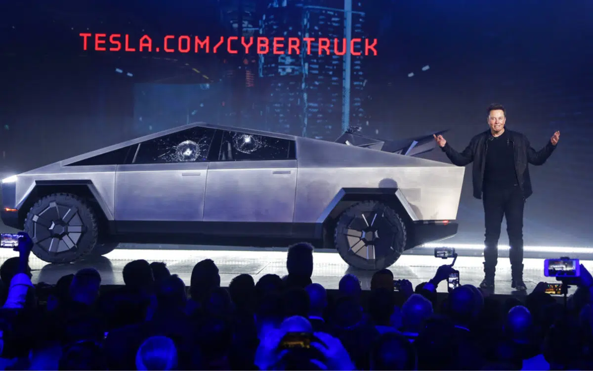 Tesla Cybertruck in a modern urban setting at dusk, showcasing its unique design and technology.