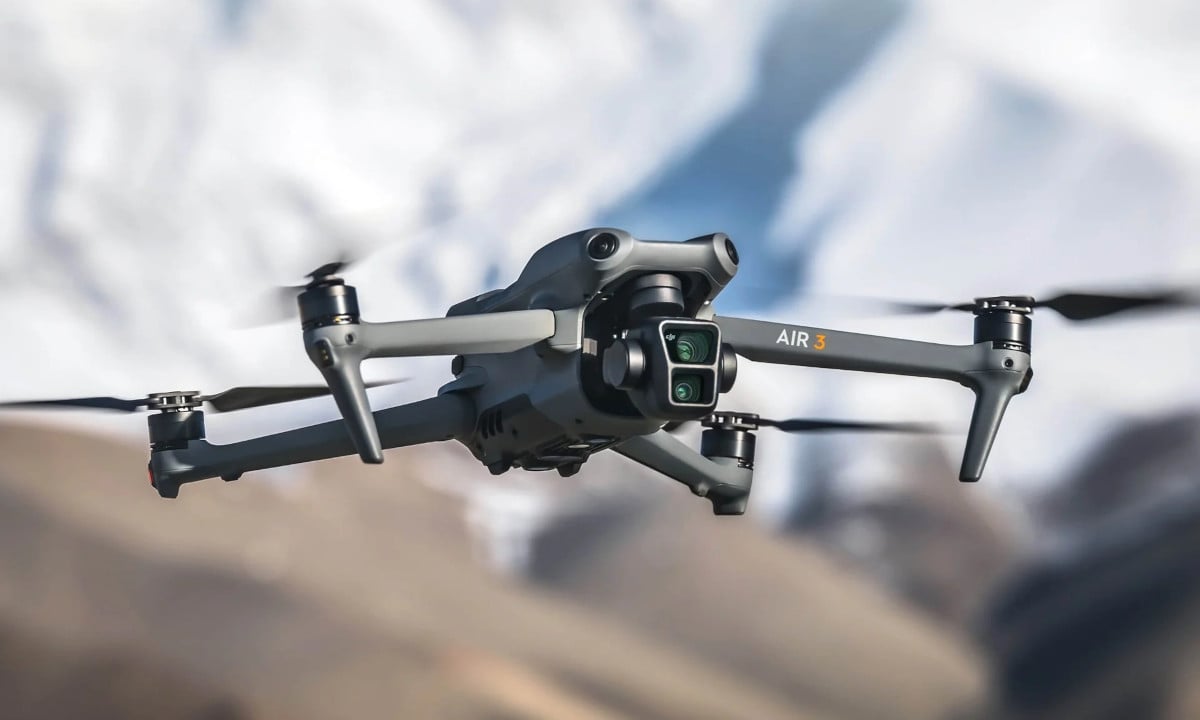 A stunning illustration of the DJI Air 4 drone flying over a picturesque landscape during sunset, highlighting its new features and sleek design.