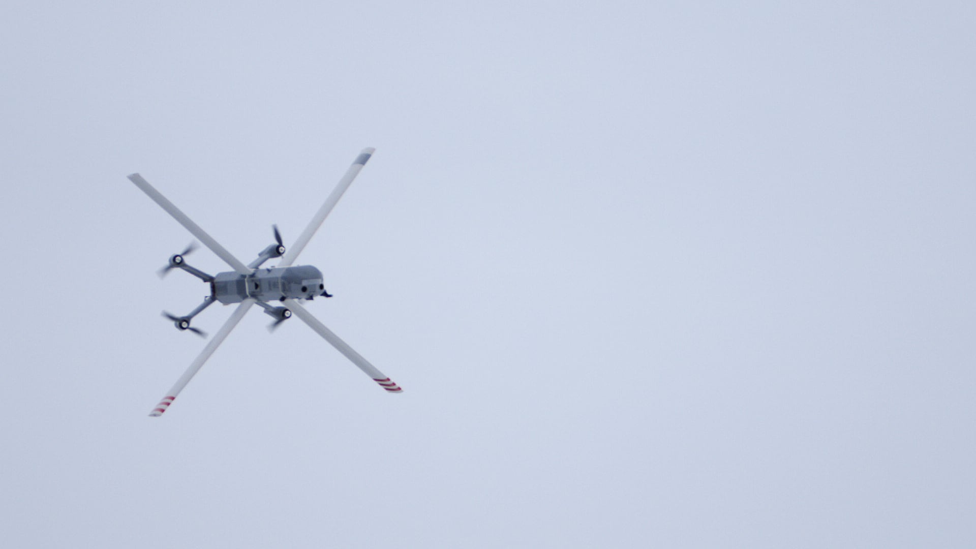 Futuristic Helsing HX-2 drones flying over a European landscape, symbolizing modern defense strategy.