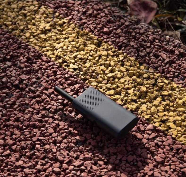 A modern illustration of Xiaomi Walkie-Talkie 3 in a vibrant outdoor setting, showcasing technological features and user engagement.